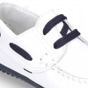 Classic white nappa leather Boat shoes with shoelaces and soles in navy color for kids.