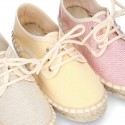 Laces up espadrille shoes in washing effect cotton canvas in pastel colors.