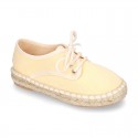 Laces up espadrille shoes in washing effect cotton canvas in pastel colors.