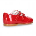 Classic little Mary Jane shoes in RED patent leather with double buckle fastening and perforated design.