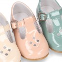 Little T-Strap shoes with perforated design in patent leather in pastel colors.