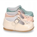 Little T-Strap shoes with perforated design in patent leather in pastel colors.