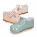 Little T-Strap shoes with perforated design in patent leather in pastel colors.