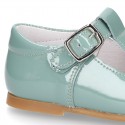 Little T-Strap shoes with perforated design in patent leather in pastel colors.