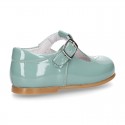 Little T-Strap shoes with perforated design in patent leather in pastel colors.