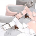 Patent leather Little T-Strap Sandal shoes with buckle fastening and with bows and pearls design.