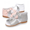 Patent leather Little T-Strap Sandal shoes with buckle fastening and with bows and pearls design.