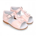 Patent leather Little T-Strap Sandal shoes with buckle fastening and with bows and pearls design.