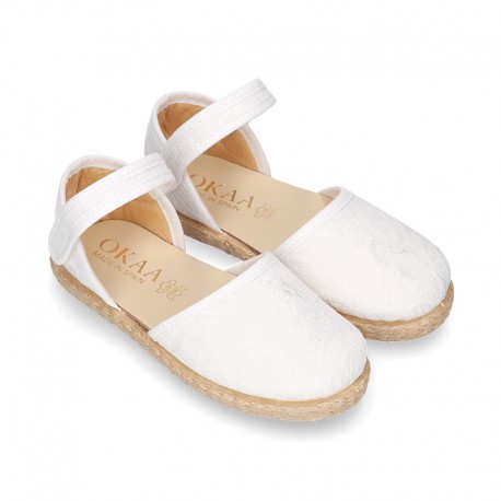 White canvas espadrille shoes with LACES design and velcro strap closure.