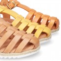 Cowhide leather sandal shoes caged type design with white soles.