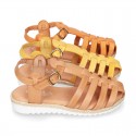 Cowhide leather sandal shoes caged type design with white soles.