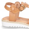 Cowhide leather sandal shoes caged type design with white soles.