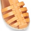 Cowhide leather sandal shoes caged type design with white soles.