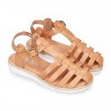 Cowhide leather sandal shoes caged type design with white soles.