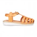 Cowhide leather sandal shoes caged type design with white soles.