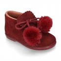 Booties with shoelaces closure with POMPONS in suede leather for kids.