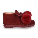 Booties with shoelaces closure with POMPONS in suede leather for kids.