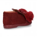 Booties with shoelaces closure with POMPONS in suede leather for kids.