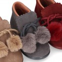 Booties with shoelaces closure with POMPONS in suede leather for kids.