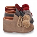 Booties with shoelaces closure with POMPONS in suede leather for kids.