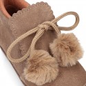 Booties with shoelaces closure with POMPONS in suede leather for kids.