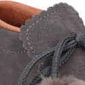 Booties with shoelaces closure with POMPONS in suede leather for kids.