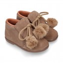 Booties with shoelaces closure with POMPONS in suede leather for kids.