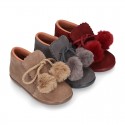 Booties with shoelaces closure with POMPONS in suede leather for kids.