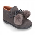 Booties with shoelaces closure with POMPONS in suede leather for kids.