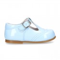 Classic little patent leather T-strap shoes in soft colors.