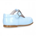 Classic little patent leather T-strap shoes in soft colors.