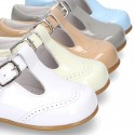 Classic little patent leather T-strap shoes in soft colors.
