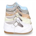 Classic little patent leather T-strap shoes in soft colors.