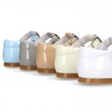 Classic little patent leather T-strap shoes in soft colors.