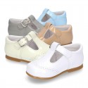 Classic little patent leather T-strap shoes in soft colors.