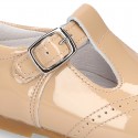 Classic little patent leather T-strap shoes in soft colors.