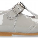 Classic little patent leather T-strap shoes in soft colors.