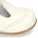 Classic little patent leather T-strap shoes in soft colors.