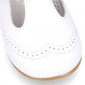 Classic little patent leather T-strap shoes in soft colors.