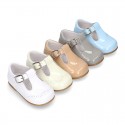 Classic little patent leather T-strap shoes in soft colors.