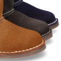 Suede leather Boots with velcro strap closure and fake hair lining.