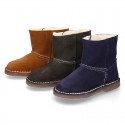 Suede leather Boots with velcro strap closure and fake hair lining.