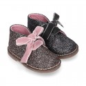 Classic GLITTER safari boots with velvet ties closure .