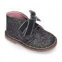 Classic GLITTER safari boots with velvet ties closure .