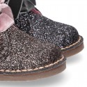 Classic GLITTER safari boots with velvet ties closure .