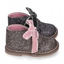 Classic GLITTER safari boots with velvet ties closure .