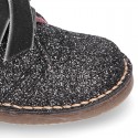 Classic GLITTER safari boots with velvet ties closure .