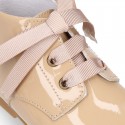 Classic pastel color patent leather ankle boots to dress with ties closure for first steps.