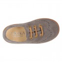 Suede leather kids Laces up style shoes with perforated design.