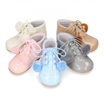 Classic patent leather English style bootie for first steps with POMPONS.